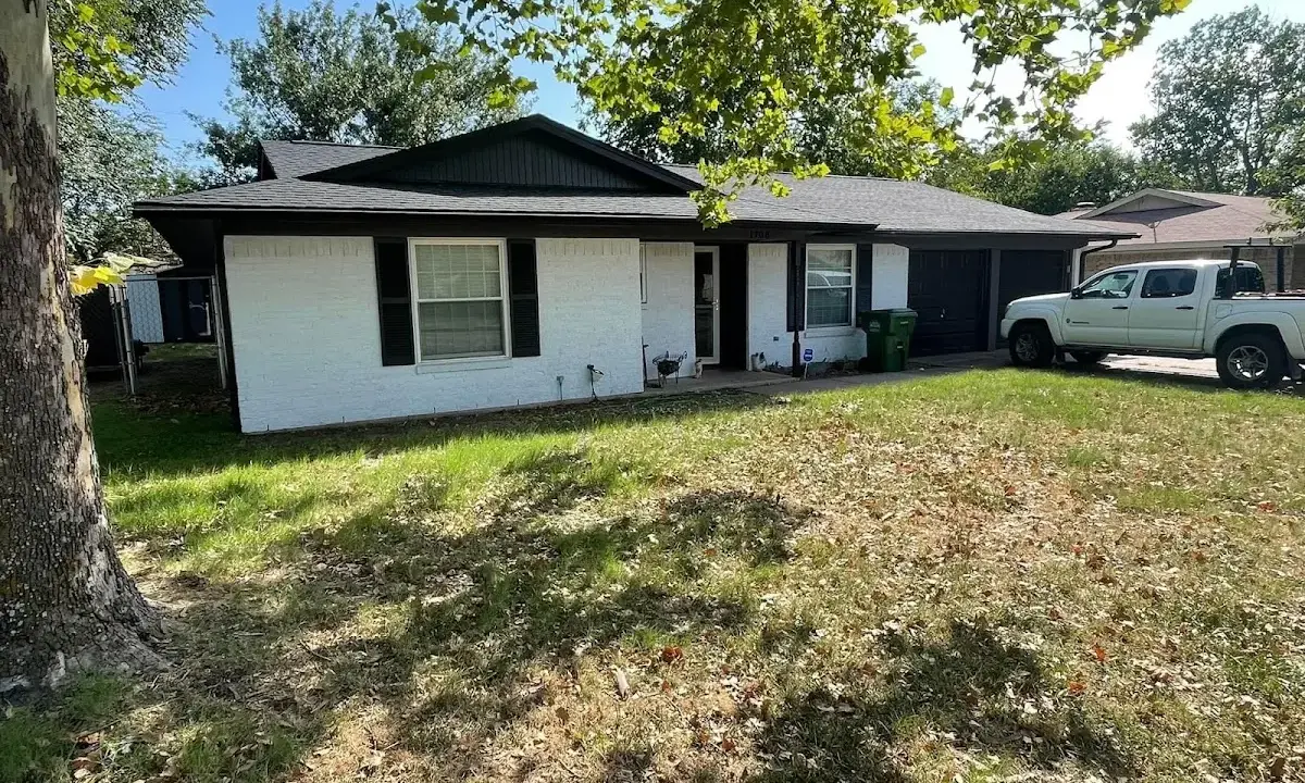 Professional roofing crew working on a residential roof in East Grand Forks